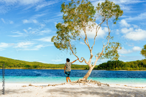 Man looking at Lake Mckenzie against sky, Fraser Island, Queensland, Australia