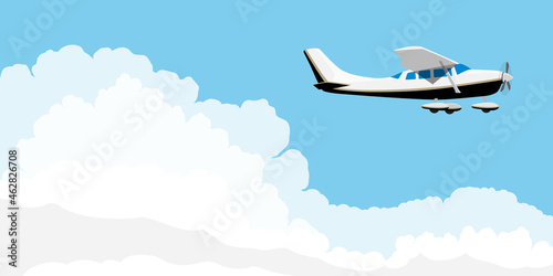 Small single engine airplane cessna flying in blue sky with clouds