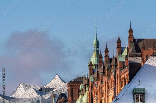 The fabulous Speicherstadt in Hamburg on a cold winter day with the roof of the Elbphilharmonie and blue sky