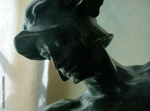 Head of statue of Eros close up.