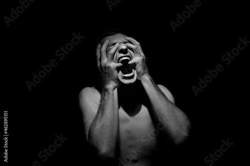 emotional photo, man shouting on black background