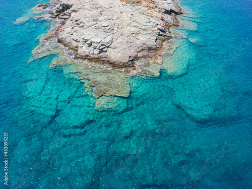 Azure water texture, transparent sea surface with a rocky bottom. Aerial view, natural blue background