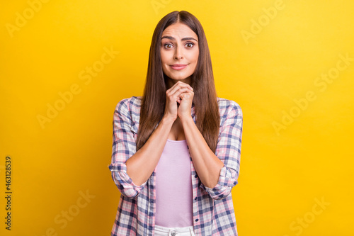 Photo of young attractive woman happy positive smile hands together please beg wait isolated over yellow color background