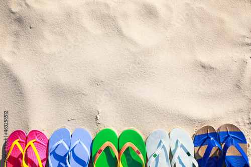 Stylish flip flops on beach, flat lay. Space for text