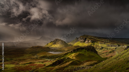 Dramatic landscape Isle of Skye, part of the Scottish Highlands and Islands, iconic, historic and famous landmark of the Quirang during a morning storm and weather front