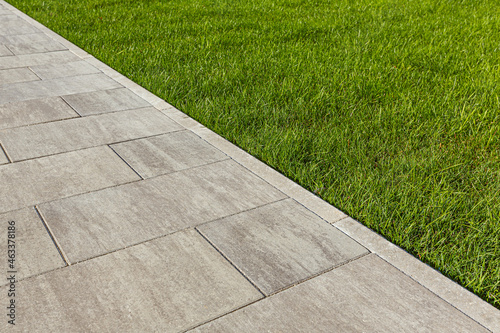 The curb along the edge of the walkway is flush with the paving. Selective focusing.