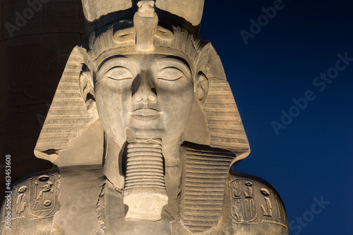 The statue of Ramesses II Illuminated at night in the temple of Luxor