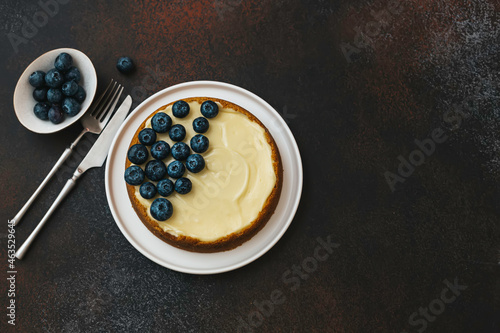Classical New York cheesecake with blueberries. Homemade baking.