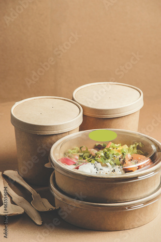 Modern sustainable food delivery with healthy lunch in plastic free boxes from craft-paper. Eco-friendly lifestyle with biodegradable material. Front view.