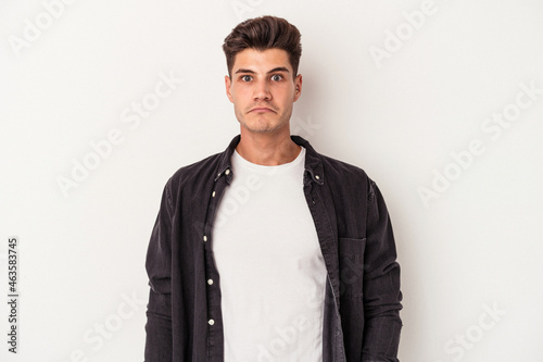 Young caucasian man isolated on white background sad, serious face, feeling miserable and displeased.