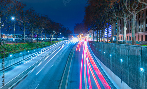 Long exposure photo of traffic on the move with Car lights trail at dusk on the road - Lyon, France