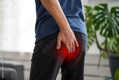 Hemorrhoidal pain, man suffering from hemorrhoids