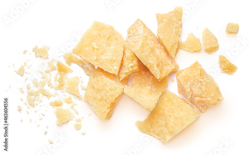 Pieces of parmesan cheese isolated on white background. Parmesan chunks with crumbs top view