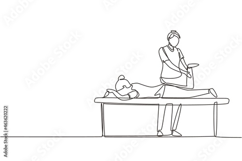 Continuous one line drawing physiotherapy rehabilitation assistance. Cute woman patient lying on massage table therapist doing healing treatment massaging injured foot. Single line draw design vector