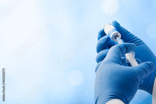 Focus on vaccine, doctor or nurse hands taking covid vaccination booster shot