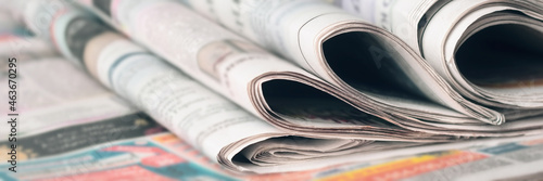 Panoramic image of old newspapers. Blur, selective focus.