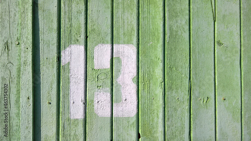 Rustic style green wooden background. Background texture of an old tree. Abstract background in light green tones, empty template. The view from the top. The old wooden table is green. Number 13
