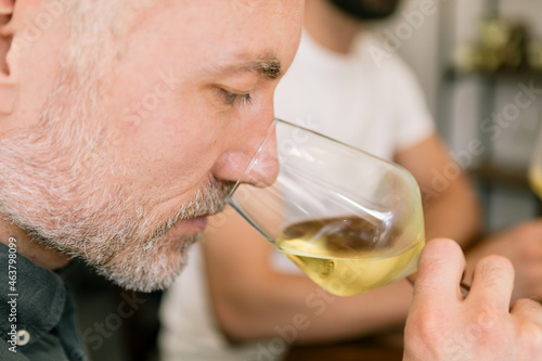 sommelier smelling a glass of white wine at the organic and biodynamic wine fair