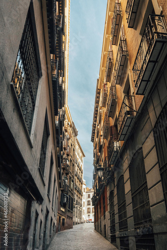 Vertical shot of a narrow European-style alley in Madrid, Spain