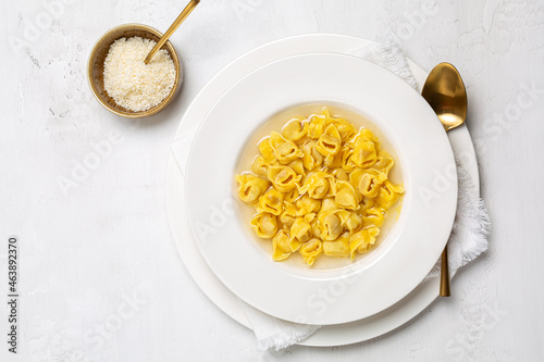 Tortellini. Pasta stuffed with a mix of meat, and parmigiano cheese and served in capon broth. Top view, white background.