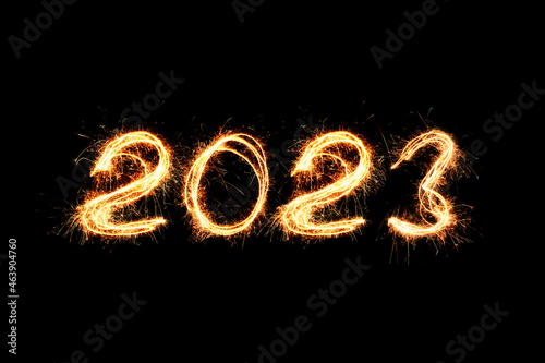 New Year 2023 light. Sparklers draw figures 2023. Bengal lights and letter