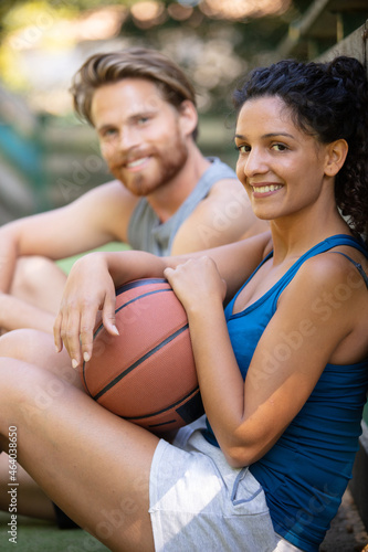 couple relaxing after playing basketball