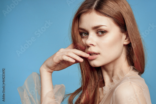 pretty woman in beige dress posing charm blue background