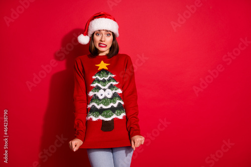 Photo of unhappy upset young woman wear ugly print sweater empty space isolated red color background