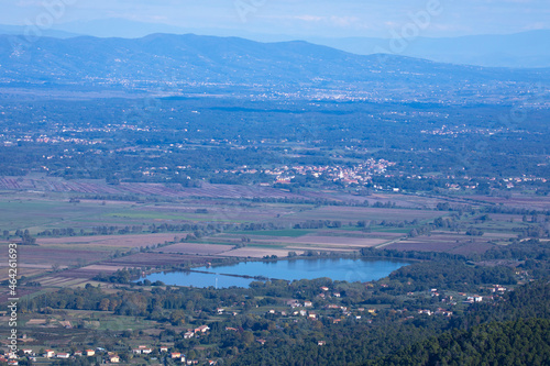 view from the top of the mountain to the city of Capannori , lake della Gherardesca and its surroundings in Italy in early autumn