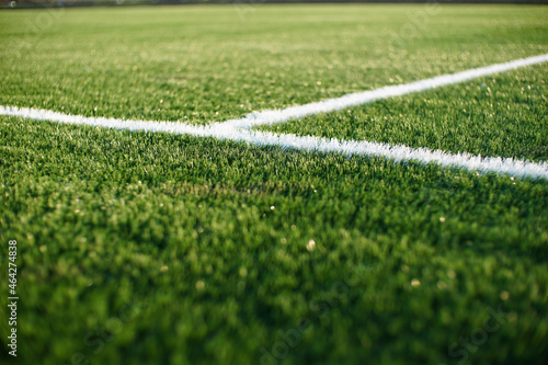 green synthetic grass surface on a soccer ground, european football field with artificial grass