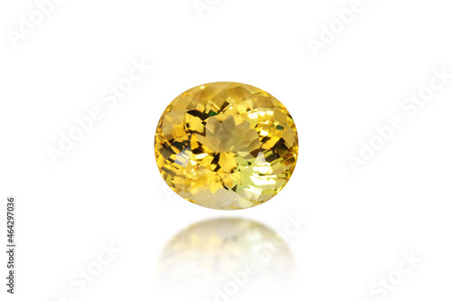 Genuine Brazilian unheated yellow color citrine gemstone. Loose oval shape faceted transparent stone with some small natural inclusions. White background isolated closeup makro, blured semireflection.