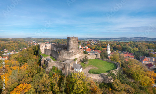 Aerial view of Bolkow Castle surrounded by yellow autumn trees, Lower Silesia, Poland