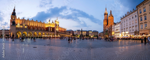 A panorama picture of Krakow`s Main Square Rynek Główny featuring the Cloth Hall, St. Mary`s Basilica and the Town Hall Tower