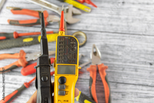 Probe voltage tester with repairing tools and instruments on the background