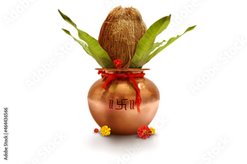 Indian festival akshaya tritiya, Wedding concept : Decorative Copper kalash with coconut and mango leaf with floral decoration on a white background. Essential in Hindu Puja.