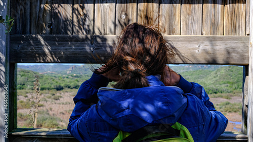 Parc Natural de s'Albufera des Grau, Menorca, Spain. woman looks from behind observation point