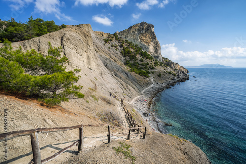 Part of trekking route named 'Golitsyn trail' near by mountains andcoastline of Black Sea. Scenic tree on right side, Blue Bay is on left. Novyi Svit, Crimea