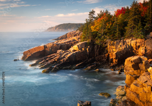 Acadia National Park, ME - USA - Oct. 13, 2021: Horizontal view of sunrise at Newport Cove in Acadia National Park in Maine. Golden hour view of the coast line and forest.