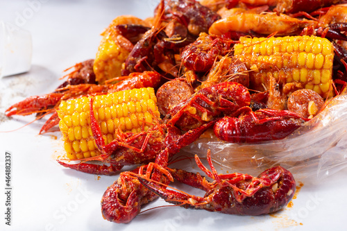 A closeup view of a pile of crawfish boil spilling out of a plastic bag.