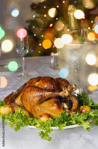 Christmas table with roast capon and bokeh in background