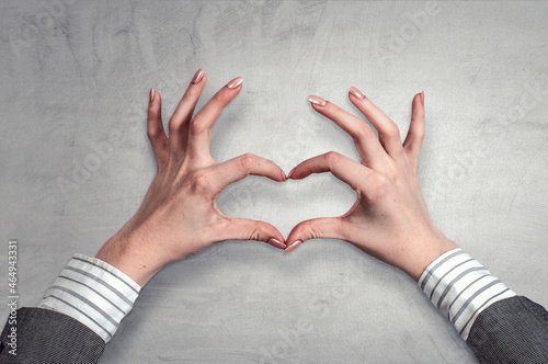 Male hands form heart shape