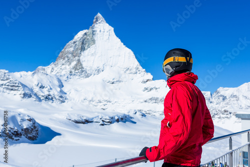 Skier enjoying the Alpine view. Snow mountain range with Matterhorn on the background. Zermatt Alps region Switzerland.
