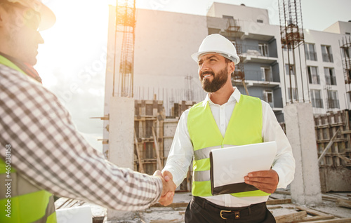 Engineers shaking hands at construction site