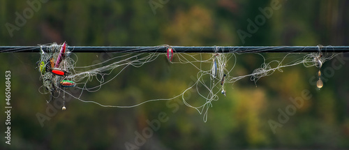 Tangle of fishing line and fishing lures on hydro line