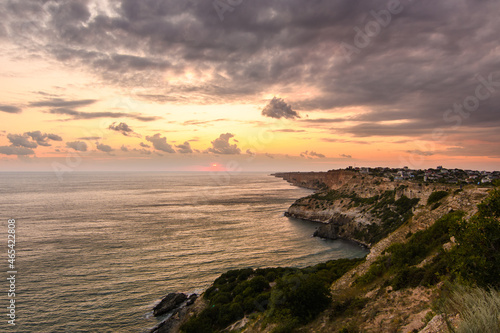 Beautiful sea sunset and rocky coast. Dramatic sky with clouds. Crimea.
