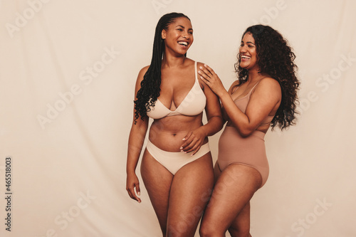 Happy young women embracing their natural bodies