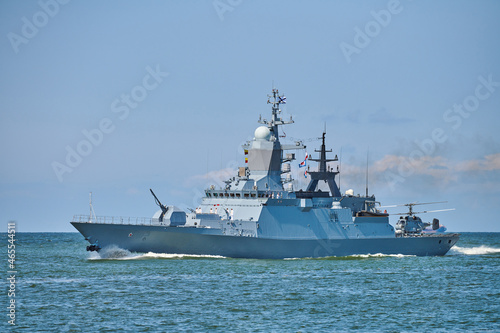 Battleship war ship boat corvette with helicopter on deck in beautiful blue sea. Navy warship