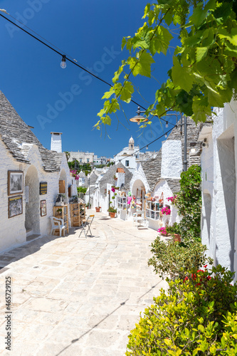 Vertical shot of architectures with cone roofs made of small stones in Alberobello, Italy