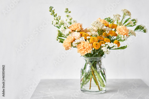 Finished flower arrangement in a vase for home. Flowers bunch, set for interior. Fresh cut flowers for decoration home. European floral shop. Delivery fresh cut flower.