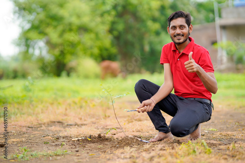 Young man doing tree plantation at field